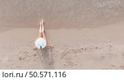 Top view of a young woman sunbathing on the beach. Стоковое фото, агентство Ingram Publishing / Фотобанк Лори