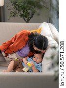 Mother and son play together after dad comes home from work. Стоковое фото, агентство Ingram Publishing / Фотобанк Лори