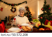 Elderly woman and lonely moments in Christmas night. Стоковое фото, агентство Ingram Publishing / Фотобанк Лори