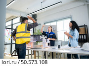 Engineers, architects, and designers collaborate to design a building that employs natural energy. Стоковое фото, агентство Ingram Publishing / Фотобанк Лори