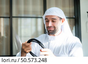 Portrait of a handsome young Arabic man in traditional clothes. Стоковое фото, агентство Ingram Publishing / Фотобанк Лори