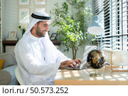Portrait of young Arabic businessman working on laptop at home. Стоковое фото, агентство Ingram Publishing / Фотобанк Лори