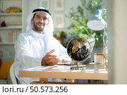Portrait of young Arabic businessman working on laptop at home. Стоковое фото, агентство Ingram Publishing / Фотобанк Лори