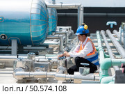 Engineers inspect the completed air conditioning and water systems to continue verifying their functionality. Стоковое фото, агентство Ingram Publishing / Фотобанк Лори