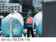 Engineers inspect the completed air conditioning and water systems to continue verifying their functionality. Стоковое фото, агентство Ingram Publishing / Фотобанк Лори