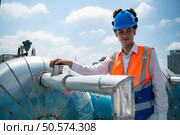 Engineers inspect the completed air conditioning and water systems to continue verifying their functionality. Стоковое фото, агентство Ingram Publishing / Фотобанк Лори