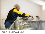 Young woman working in wine cellar at winery. Стоковое фото, агентство Ingram Publishing / Фотобанк Лори