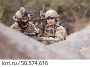 Soldiers in camouflage military uniforms carrying weapons, Reconnaissance missions in rugged mountains, Assault infantry battle training. Стоковое фото, агентство Ingram Publishing / Фотобанк Лори