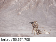 Soldiers in camouflage military uniforms carrying weapons, Reconnaissance missions in rugged mountains, Assault infantry battle training. Стоковое фото, агентство Ingram Publishing / Фотобанк Лори