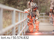 Soldiers in camouflage military uniforms carrying weapons, Reconnaissance missions in the tropical forest area, Assault infantry battle training. Стоковое фото, агентство Ingram Publishing / Фотобанк Лори