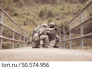 Soldiers in camouflage military uniforms carrying weapons, Reconnaissance missions in the tropical forest area, Assault infantry battle training. Стоковое фото, агентство Ingram Publishing / Фотобанк Лори