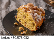 A tempting close-up of a Bolo Rainha slice, showcasing its almond topping and fruit-studded interior. This Portuguese Christmas cake is dusted with powdered sugar. Стоковое фото, агентство Ingram Publishing / Фотобанк Лори