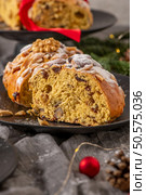 A close-up view of a slice of Bolo Rainha reveals its moist texture, studded with nuts and dried fruit, and dusted with powdered sugar. A festive treat. Стоковое фото, агентство Ingram Publishing / Фотобанк Лори