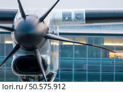 Propeller plane parking at the airport. Travel and destination background. Propeller plane parking at the airport. Стоковое фото, агентство Ingram Publishing / Фотобанк Лори