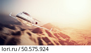 Photo of white modern and luxury generic design private jet flying in blue sky over uninhabited desert.Mountains background.Business travel concept. Horizontal,motion blurred effect.. Photo of white modern and luxury generic design private jet flying in blue sky over uninhabited desert.Mountains background.Business travel concept. Horizontal,motion blurred effect. 3d rendering. Стоковое фото, агентство Ingram Publishing / Фотобанк Лори