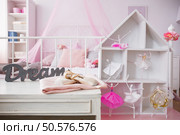 Room interior with cozy bed and stylish dollhouse. Стоковое фото, агентство Ingram Publishing / Фотобанк Лори