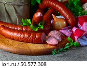 smoked sausage and onion on kitchen table. Стоковое фото, агентство Ingram Publishing / Фотобанк Лори