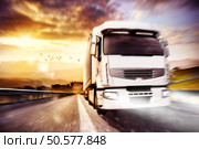 White truck on the road with the landscape at sunset. Mixed media. Truck transport. Mixed media. Стоковое фото, агентство Ingram Publishing / Фотобанк Лори