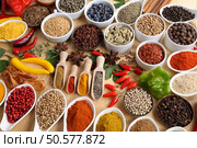 Herbs and spices in ceramic bowls. Aromatic ingredients and natural food additives. Стоковое фото, агентство Ingram Publishing / Фотобанк Лори