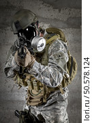 Gas Mask Soldier aiming rifle. Стоковое фото, агентство Ingram Publishing / Фотобанк Лори