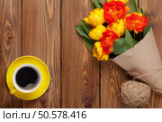 Colorful tulips bouquet and coffee cup on wooden table. Top view with copy space. Стоковое фото, агентство Ingram Publishing / Фотобанк Лори