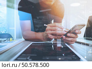 Website designer working digital tablet and computer laptop and digital design diagram on wooden desk as concept. Стоковое фото, агентство Ingram Publishing / Фотобанк Лори