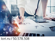Image female hand touching modern tablet.Investment manager working new private banking project office.Using electronic device. Graphic icons, worldwide stock exchanges interface on screen. . Image woman signs document, modern tablet table.Investment manager working private banking project office.Use electronic device. Graphic icons,worldwide stock exchanges interface on screen. Horizontal. Стоковое фото, агентство Ingram Publishing / Фотобанк Лори