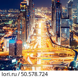 Downtown Dubai architecture by night. Aerial view of illuminated skyscrapers and highway. Famous travel destination. Стоковое фото, агентство Ingram Publishing / Фотобанк Лори