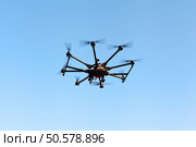 Drone on a background of a beautiful sunset. UAV in flight. Quadrocopters on radio.. Oktokopter, copter, drone. Стоковое фото, агентство Ingram Publishing / Фотобанк Лори
