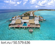 Maldives paradise scenery. Tropical aerial landscape, seascape with long jetty, water villas with amazing sea and lagoon beach, tropical nature. Exotic tourism destination banner, summer vacation. Стоковое фото, агентство Ingram Publishing / Фотобанк Лори