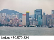 Hong Kong Cityscape View of Victoria Harbour on a Cloudy Day (2024 год). Редакционное фото, фотограф Aleksandr Golubev / Фотобанк Лори