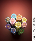 Colorful chips on a red table. Depth of field with focus on the first tokens (10000, 5000 and 1000). Clipping path included. Стоковое фото, агентство Ingram Publishing / Фотобанк Лори