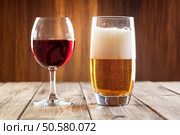 Red wine glass and glass of light beer . Стоковое фото, агентство Ingram Publishing / Фотобанк Лори