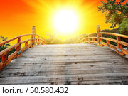 Japan is a land of a rising sun. Watching the sunrise from the Japanese bow bridge. Стоковое фото, агентство Ingram Publishing / Фотобанк Лори