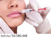 woman receiving a botox injection in her lips, close up . Стоковое фото, агентство Ingram Publishing / Фотобанк Лори