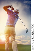 	Photograph of a golfer finishing a full swing. Стоковое фото, агентство Ingram Publishing / Фотобанк Лори