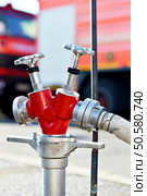 Water hose connected to hydrant during firefighting operation. Стоковое фото, агентство Ingram Publishing / Фотобанк Лори