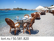 Cute chairs and table on the beach at seaside restaurant in Bodrum, Turkey . Стоковое фото, агентство Ingram Publishing / Фотобанк Лори