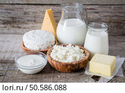 Selection of dairy products on rustic wood bacground, copy space. Selection of dairy products on rustic wood bacground. Стоковое фото, агентство Ingram Publishing / Фотобанк Лори