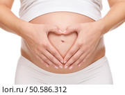 Pregnant woman loving her unborn baby. Стоковое фото, агентство Ingram Publishing / Фотобанк Лори