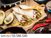 Traditional mexican tortilla wrap with a mix of ingredients. Tortilla with a mix of ingredients. Стоковое фото, агентство Ingram Publishing / Фотобанк Лори