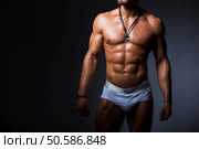 Muscular and sexy torso of young sport man with perfect abs in panties. Стоковое фото, агентство Ingram Publishing / Фотобанк Лори