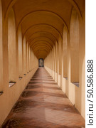 Vaulted corridor with closed security door at the end. Стоковое фото, агентство Ingram Publishing / Фотобанк Лори