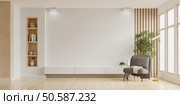 Mockup a TV wall mounted with armchair in living room with a white wall.3d rendering. Стоковое фото, агентство Ingram Publishing / Фотобанк Лори