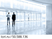 abstract image of people in the lobby of a modern business center with a blurred background. Стоковое фото, агентство Ingram Publishing / Фотобанк Лори