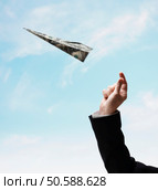 Businessman’s hand throwing airplane made of US Dollars. 24316759. Стоковое фото, агентство Ingram Publishing / Фотобанк Лори
