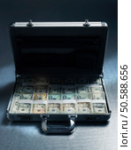 Briefcase filled with stacks of US Dollars. 24316789. Стоковое фото, агентство Ingram Publishing / Фотобанк Лори