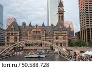 TORONTO, July 19, 2015: Nathan Phillips Square in Toronto during 2015 Pan Am & Parapan Am Games. PANAMANIA Live at Nathan Phillips Square is the epicenter of music and fun throughout the TORONTO 2015 Pan Am and Parapan Am Games. As the landmark free live site, Nathan Phillips Square will be the stage for more than 130 different performances. Toronto, Ontario, Canada. Редакционное фото, агентство Ingram Publishing / Фотобанк Лори
