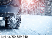 Car tires on winter road covered with snow. Vehicle on snowy alley in the morning at snowfall. Car tires on winter road. Стоковое фото, агентство Ingram Publishing / Фотобанк Лори