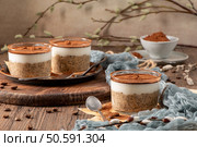 Savor a delectable tiramisu-inspired chia pudding, featuring layers of creamy coffee-infused chia and a decadent chocolate topping. This guilt-free breakfast or dessert blends classic flavors with wholesome ingredients for a convenient and satisfying treat. Стоковое фото, агентство Ingram Publishing / Фотобанк Лори